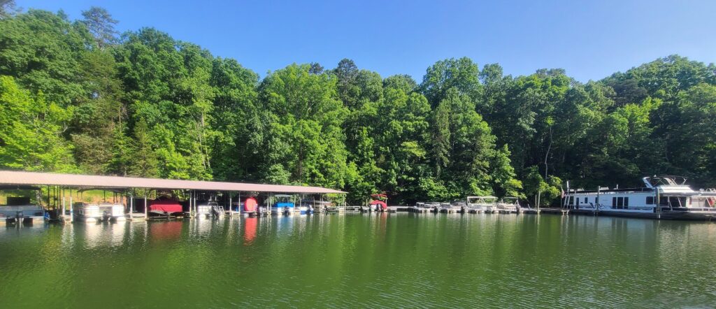 Covered boat slips at Long Cove Marina, nestled along the lush, green shoreline of Lake Wylie in Charlotte, North Carolina